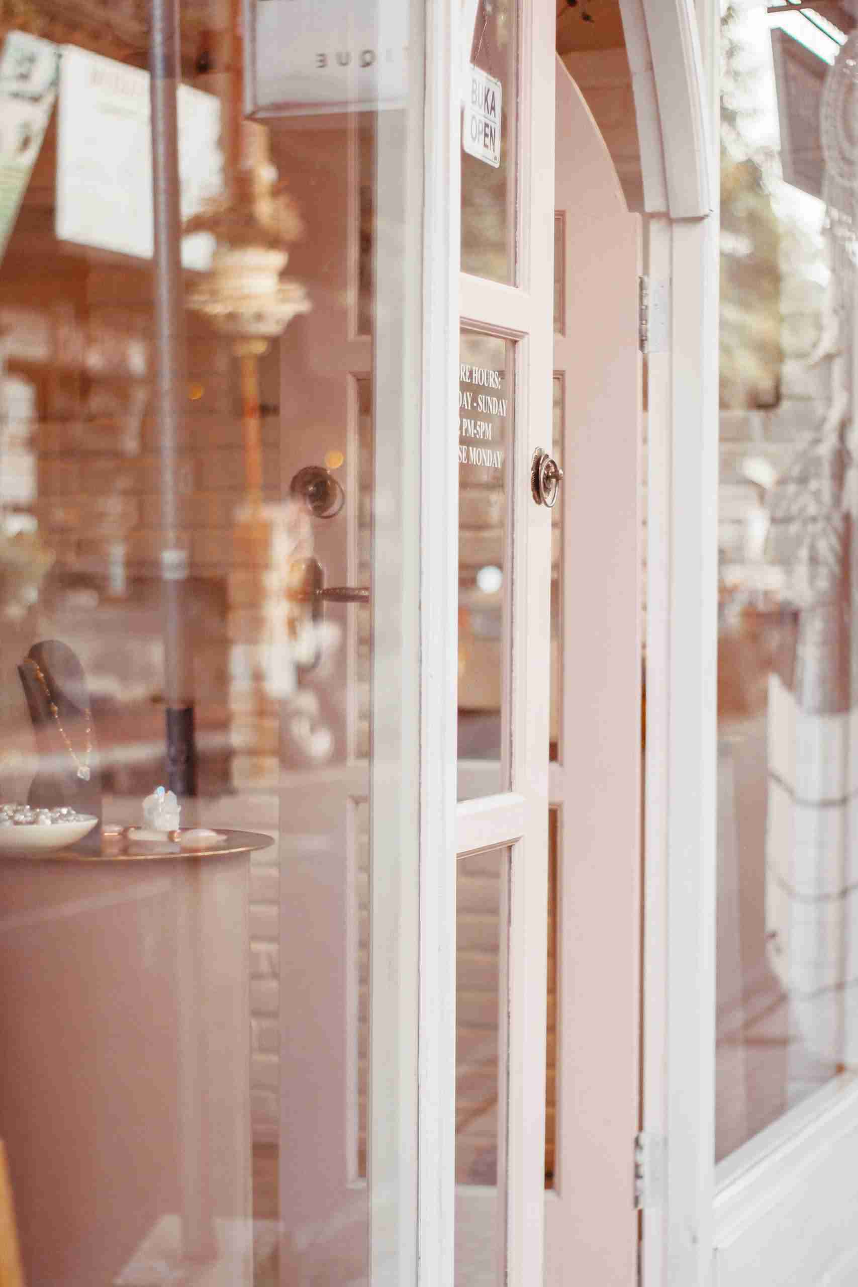 Elegant jewelry store entrance showcasing glass reflections and interior display.